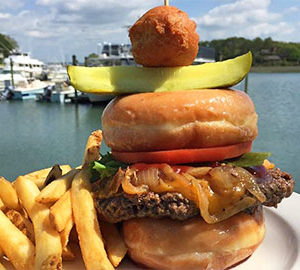 Where to Eat at South Beach. large hamburger with fries in front of a marina
