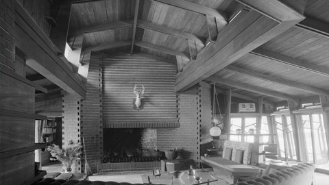 Frank Lloyd Wright's Auldbrass. black and white photo of large room with wood walls