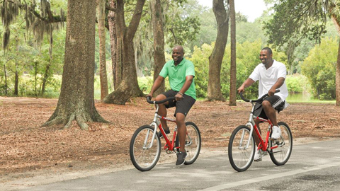 Safe Biking on Hilton. two people on red bikes