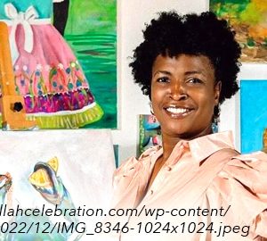 Gullah Celebration's Featured Artist woman in front of paintings