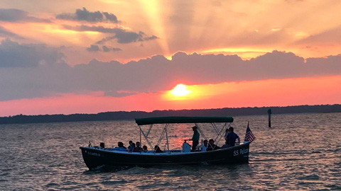 Weddings with Dolphin & Nature Tour. a boat on the water