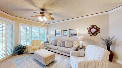 404 Windsor Place. A living room with 2 chairs, a sofa, an ottoman.