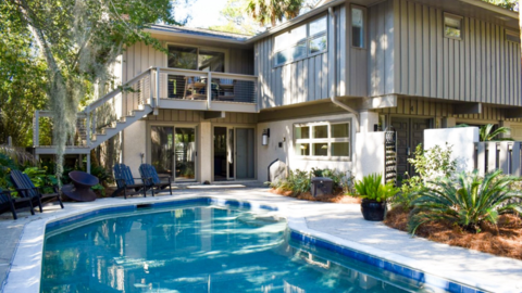 Hilton Head Exclusives. a house that has a pool