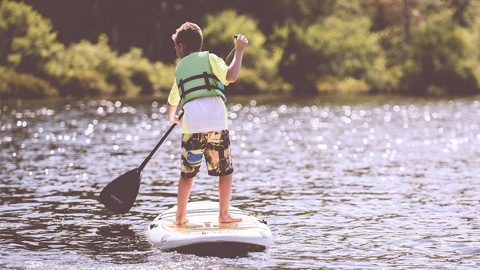 Summer Camps on Hilton Head. a little boy on a paddle board