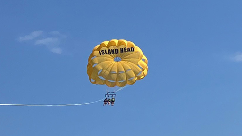 Going UP and DOWN with Island Head Parasailing. a yellow parasail