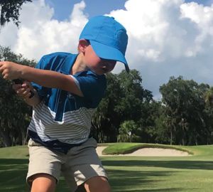Start Your Kids NOW for a Lifetime Love of Golf. a little boy golfing