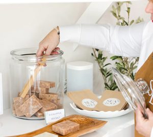 Sea Love Hilton Head. a woman grabbing something from a large jar