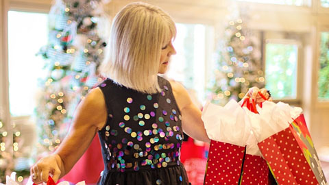 Holiday Markets and Open Houses. a woman holding up shopping bags