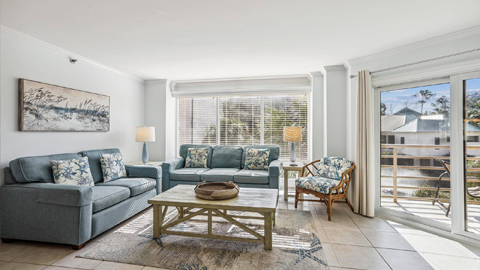 2114 Villamare. a living room with blue sofas