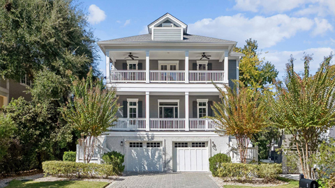 5 Sand Dollar. a 3 story gray house with black shutters