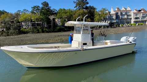 Family Fishing Excursions Aboard the Boomerang. a twin engine boat in the water with fishing poles