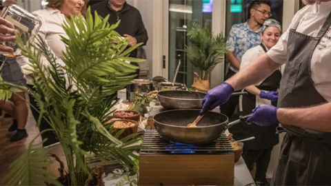 savor sea pines. a chef cooking in front of people
