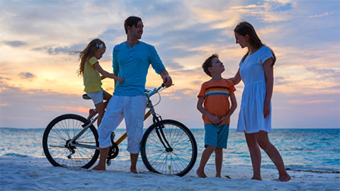 mike's bikes. A family of four on the beach