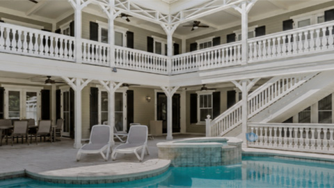 3 Armada Street. an interior of a white house with wrap-around porches and a swimming pool